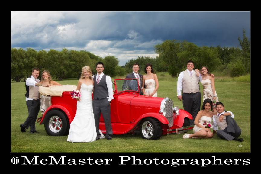 Bridal party with red car