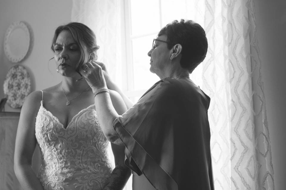 Bride putting on veil