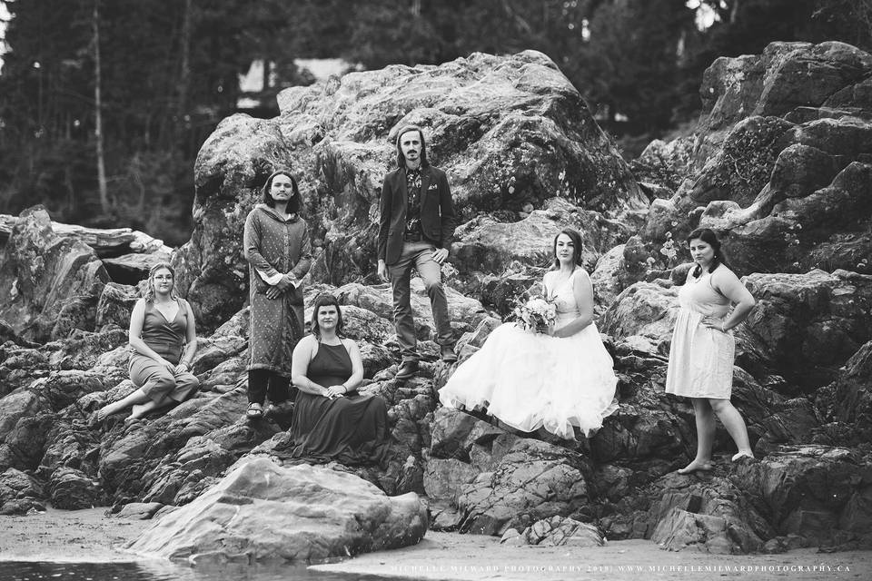 Bridal party sitting on rocks