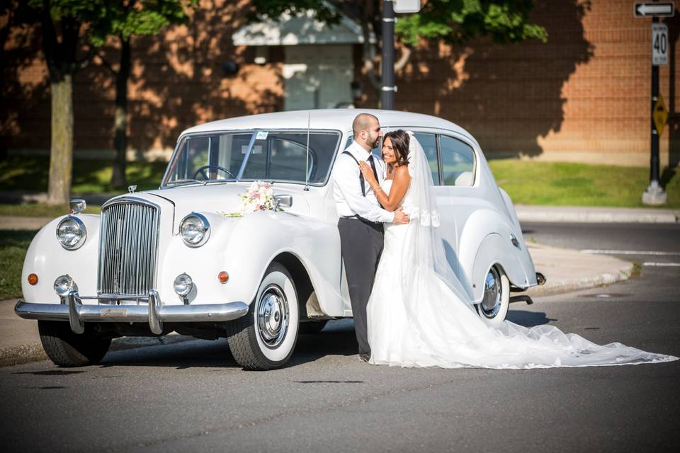 The happy couple and their wedding car