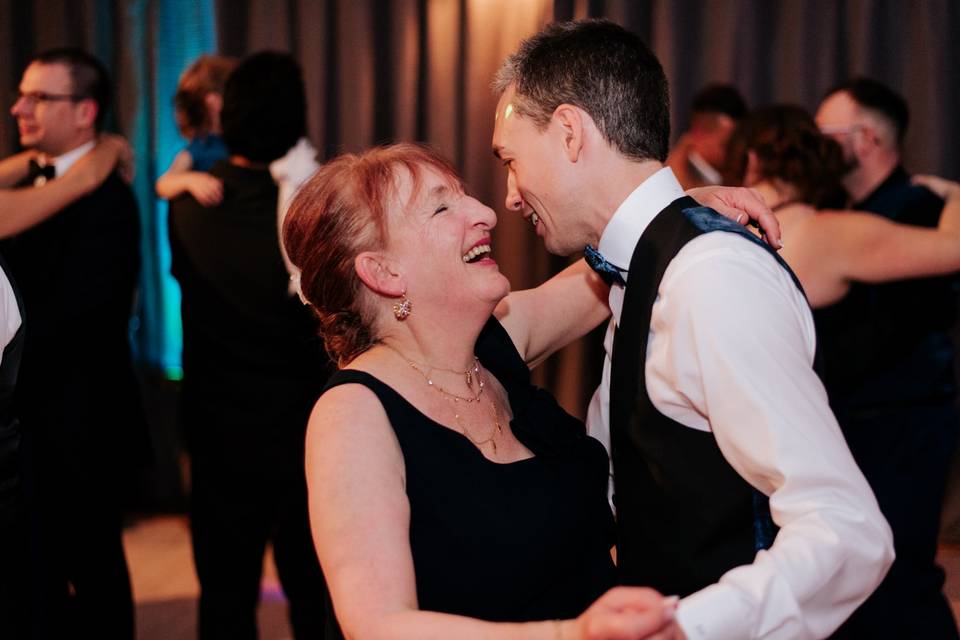 Groom and his mom dancing