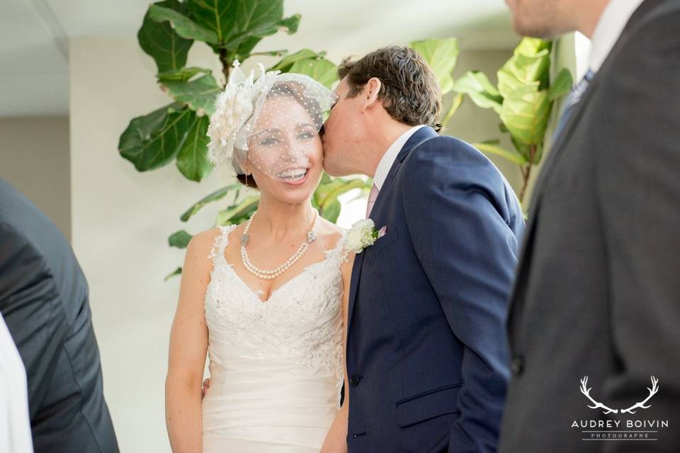 Bride and groom ceremony kiss