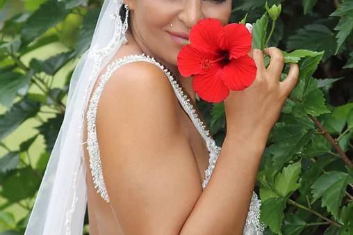 Bride sniffing flower