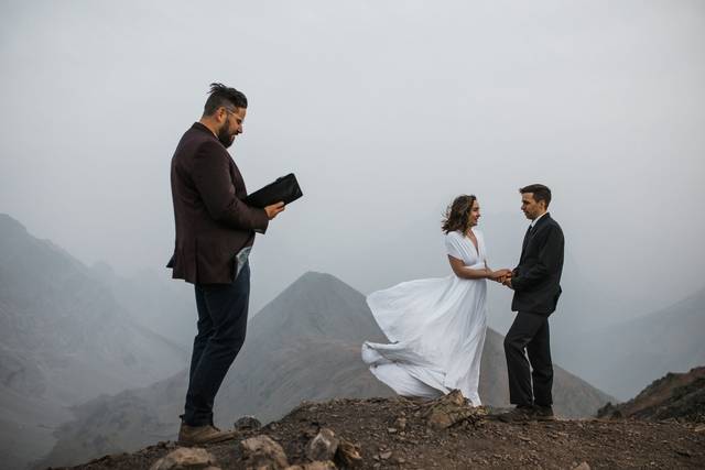 Hiking officiant on top of a m