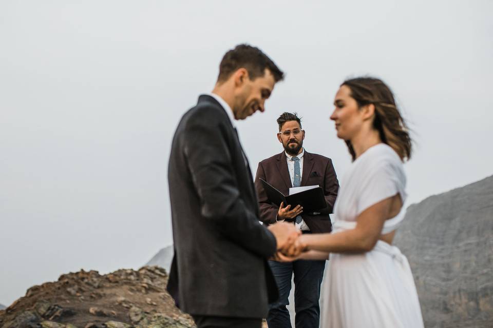 Hiking officiant on top of a m