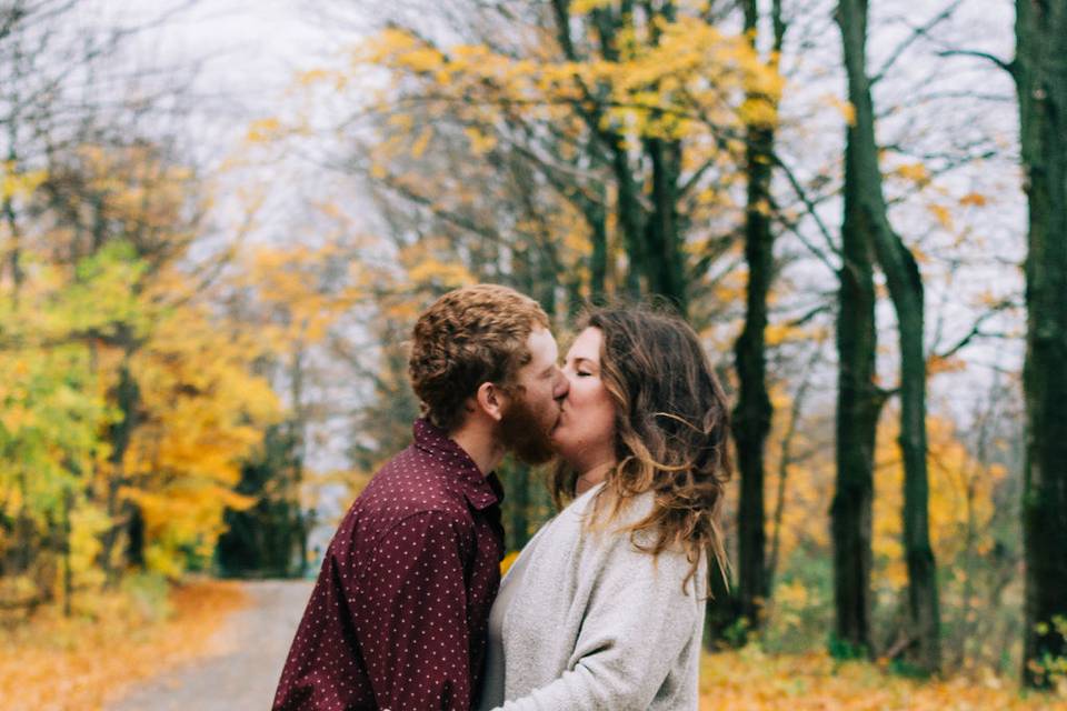 Fall lovers kissing by the tree