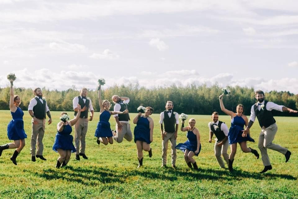 Wedding party jumping for joy