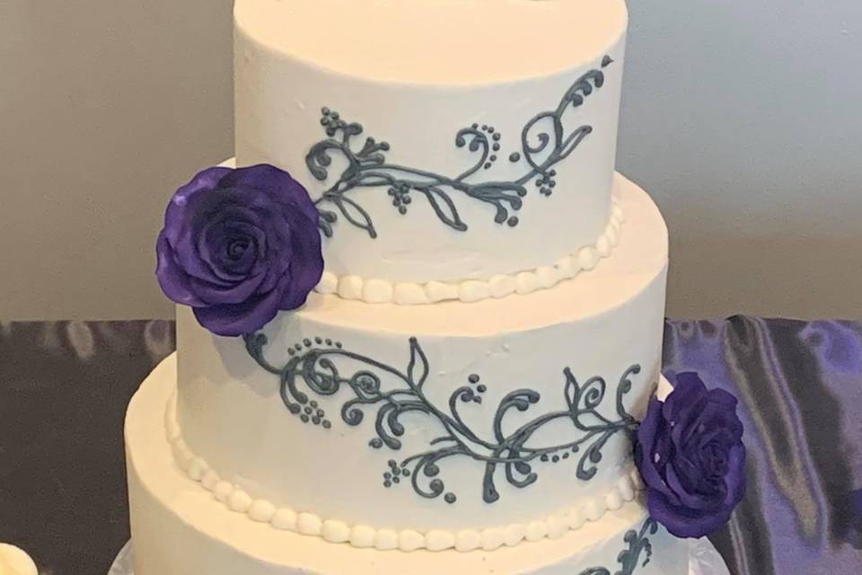 Three-tier cake with hand-piped design