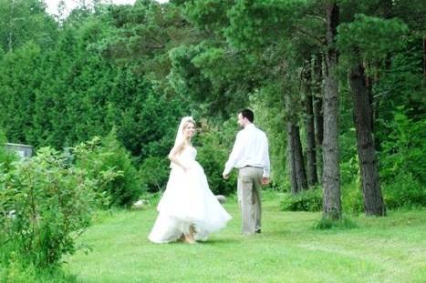 bride and groom walking through garden path at the cottage.jpg
