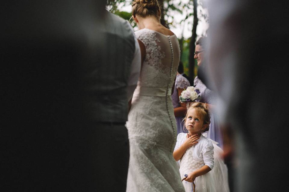 Flower girl looking at bride