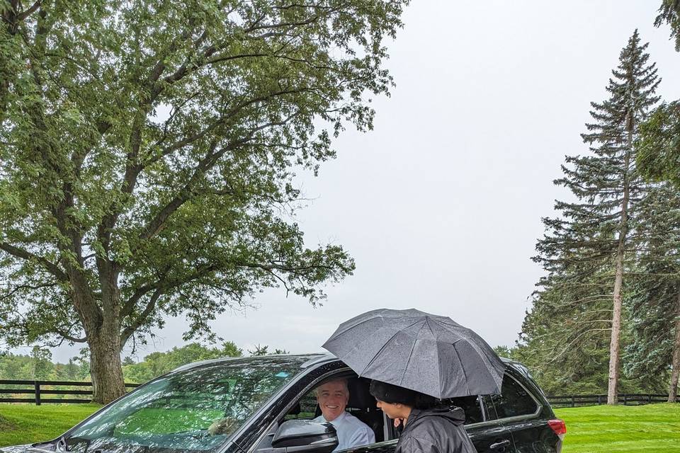 Offering umbrellas in the rain