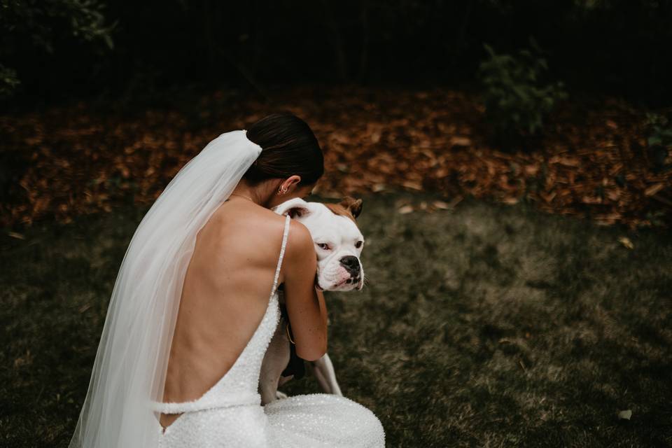 Bride hugging dog