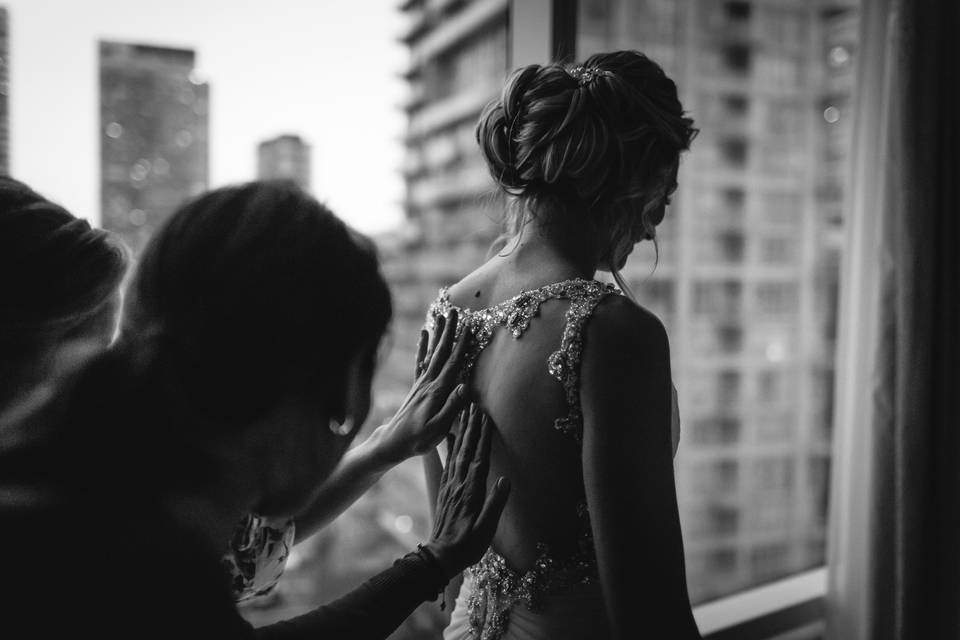 Bride having her dress done up