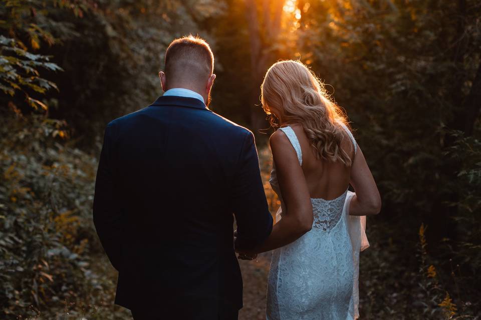 Bride and groom sunset walk