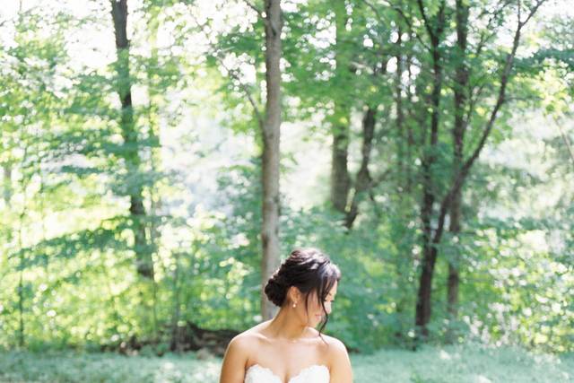 Bride holding bouquet in fores