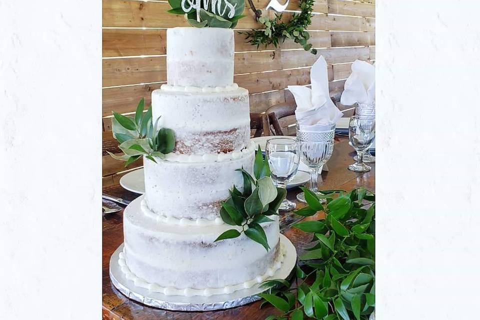 White cake with greenery
