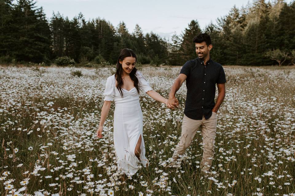 Couple walking in daisy field