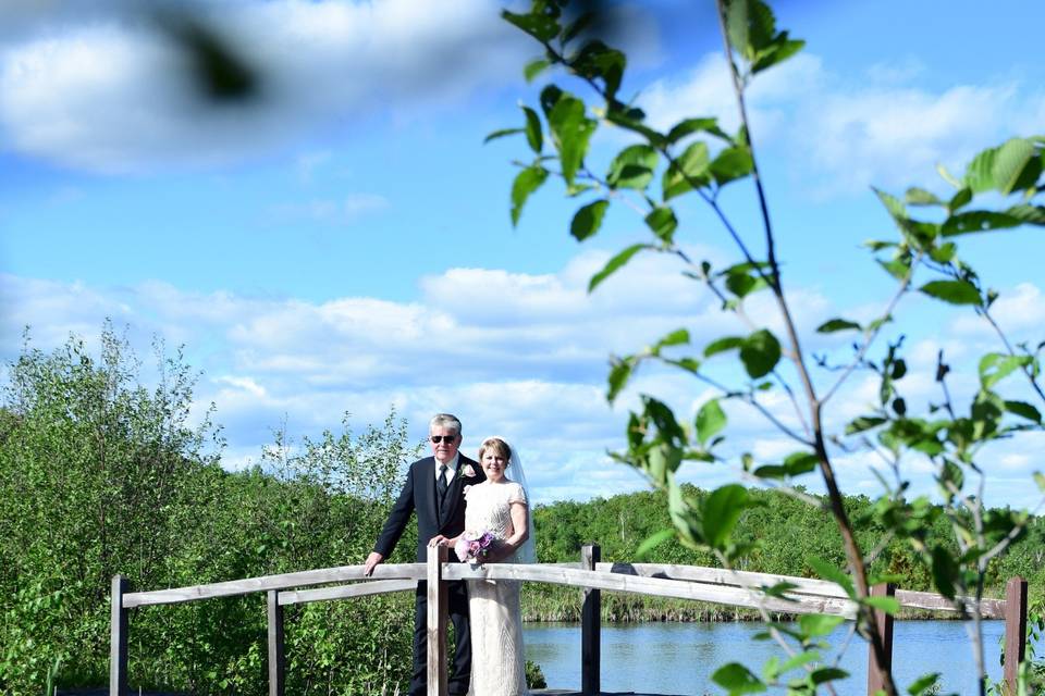 Couple posing on a bridge