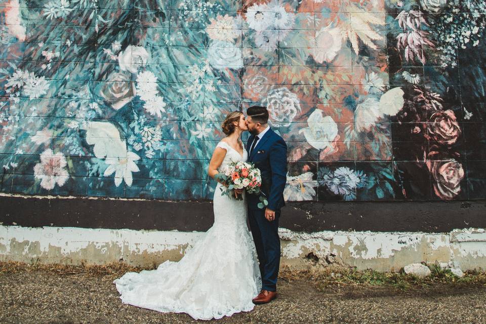 Bride and groom by the mural