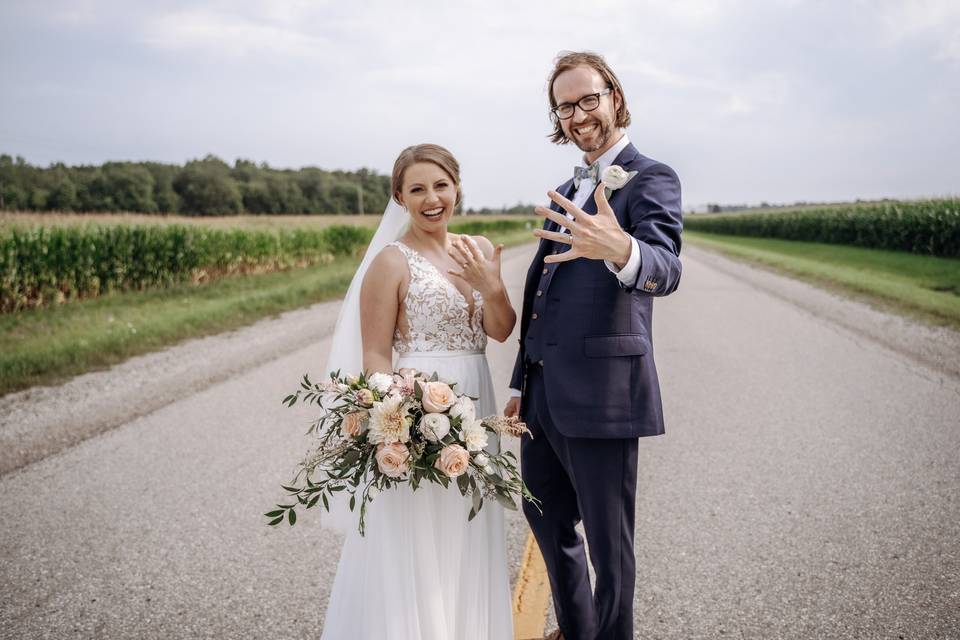 Bride and Groom showing off ri